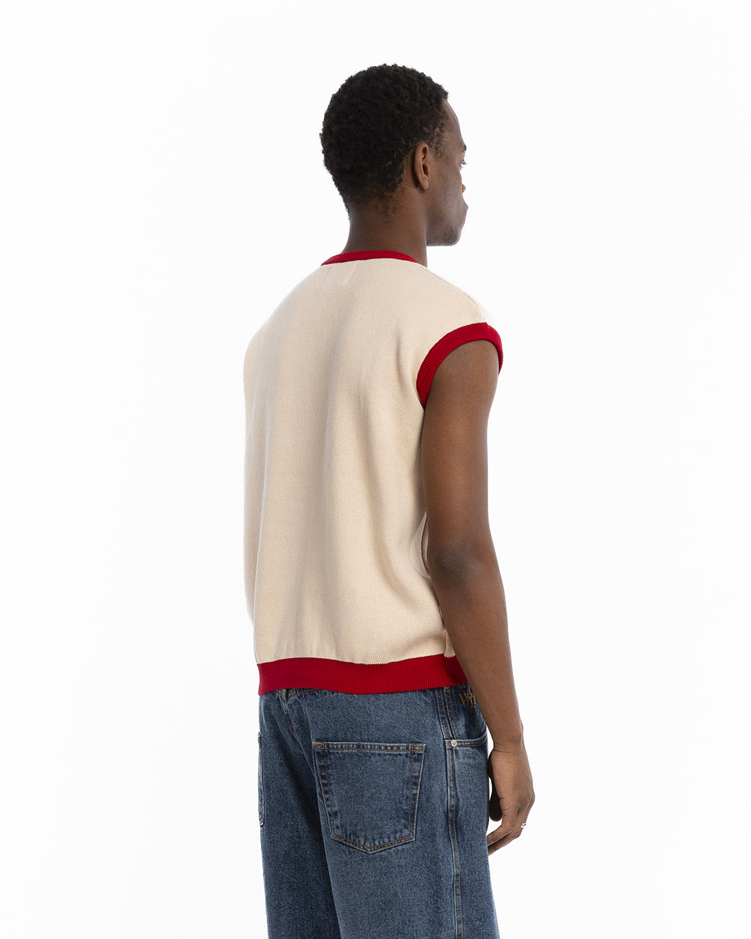 The sleeveless red knit sweater